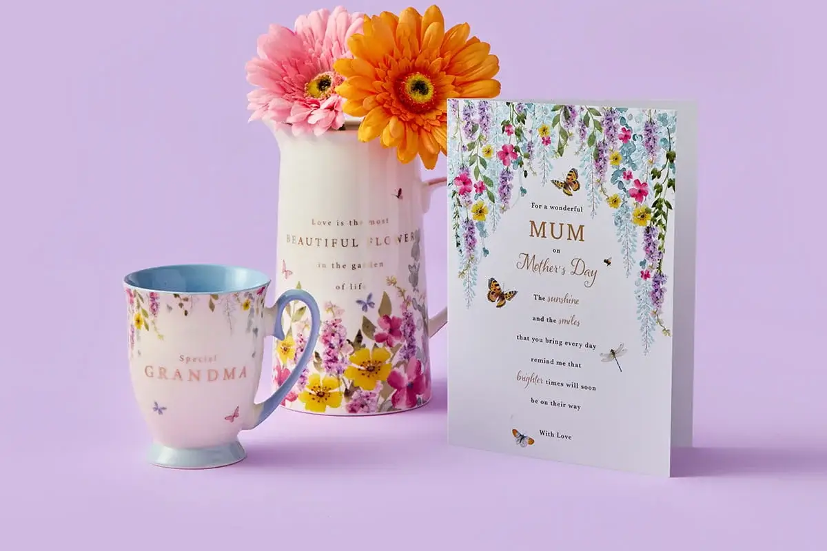A colourful Mother’s Day set featuring a floral MUM card, a tulip‑patterned mug with matching coaster, a tall floral tumbler, and a single red tulip arranged on a pastel purple background. A colourful Mother’s Day set featuring a floral MUM card, a tulip‑patterned mug with matching coaster, a tall floral tumbler, and a single red tulip arranged on a pastel purple background.